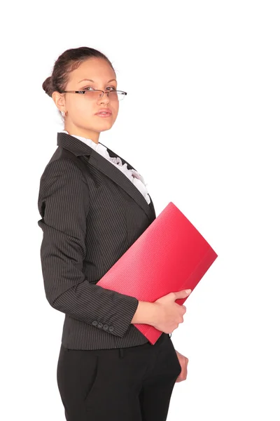 Beautiful brown-haired woman stands with red folder in hand — Stock Photo, Image