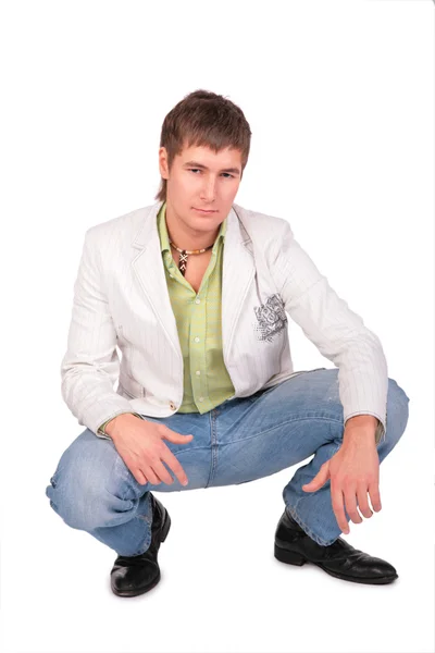 Serious young man sits — Stock Photo, Image