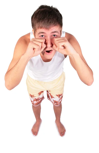 Mladý muž v šortkách tře oči — Stock fotografie