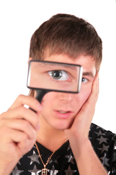 Young man looks through magnifier — Stock Photo, Image