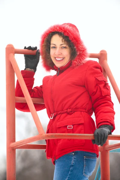 Pretty woman on metallic ladder in winter — Stock Photo, Image