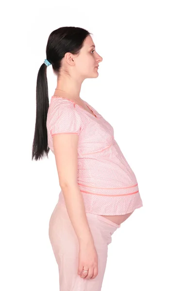Těhotná dívka pózuje boční — Stock fotografie