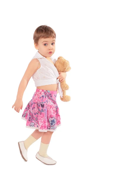 Liten flicka i kjol med leksak — Stockfoto