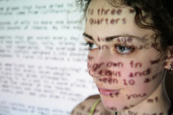 Text is projected on face of woman — Stock Photo, Image