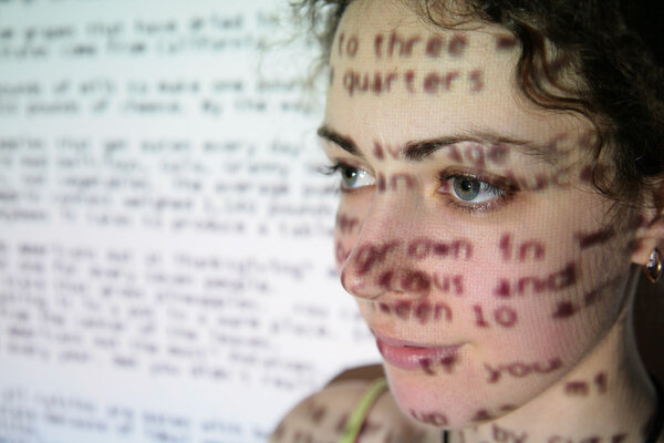 Text is projected on face of woman