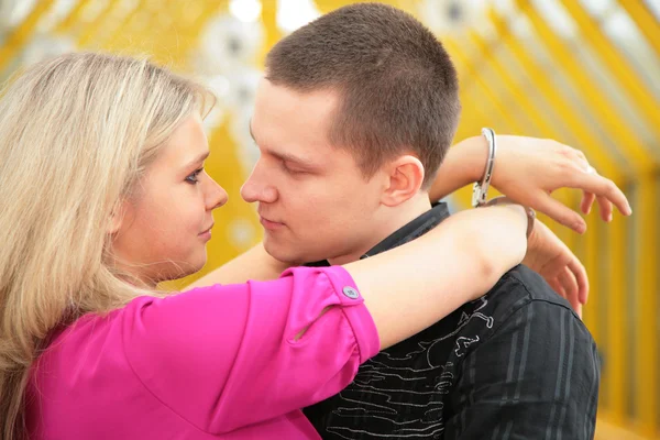 Young man and blonde in handcuff look each other — Stock Photo, Image