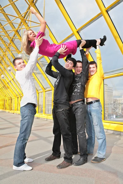 Four boys lift girl up — Stock Photo, Image