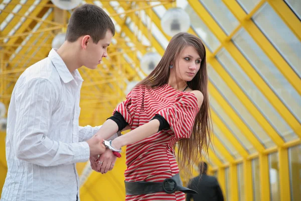 Young couple with handcuffs — Stock Photo, Image