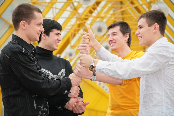 Group of young men make piramid from hands — Stock Photo, Image
