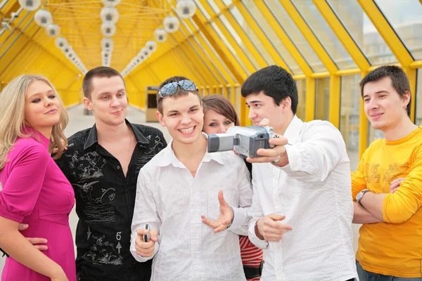 Group of young removes itself to camcorder on footbridge — Stock Photo, Image