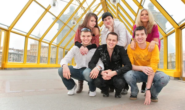 Group of young pose on footbridge — Stock Photo, Image
