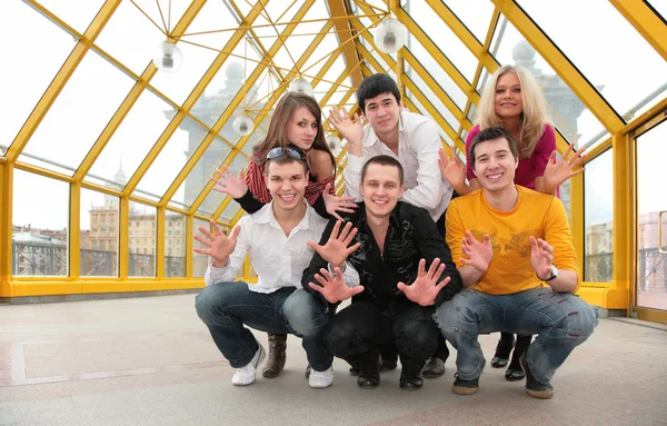Group of young demonstrates open palms on footbridge — Stock Photo, Image