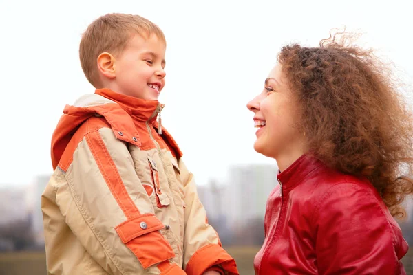 Close-up mother and son look on each other outdoor on spring — Stock Photo, Image