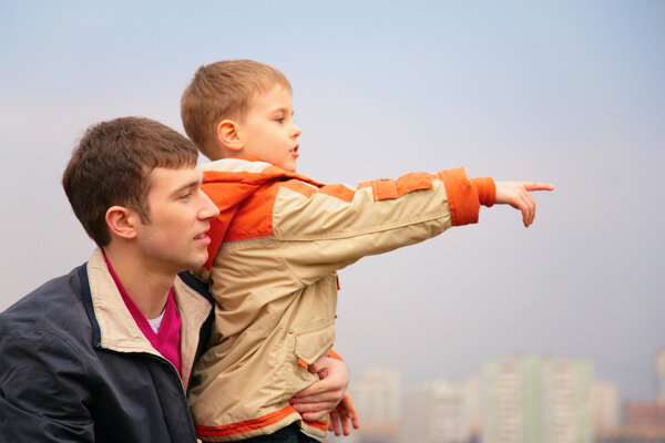 Father with son who points finger to right