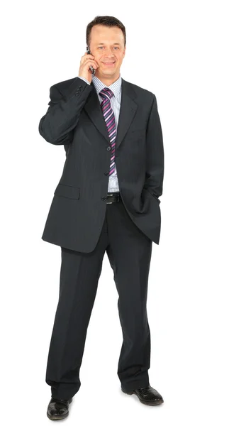 Homem de negócios fala por telefone celular — Fotografia de Stock
