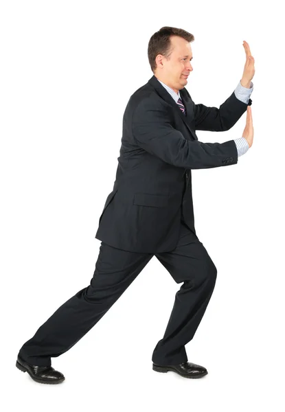 Businessman rests hands against wall — Stock Photo, Image
