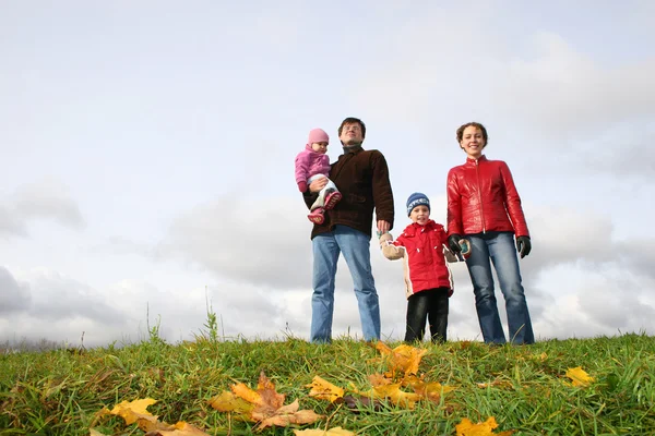 Family stand on meadow at autumn — Stock Photo, Image