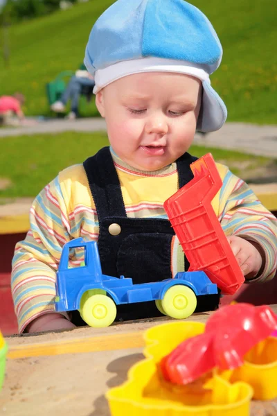 Criança e brinquedo carro ao ar livre — Fotografia de Stock