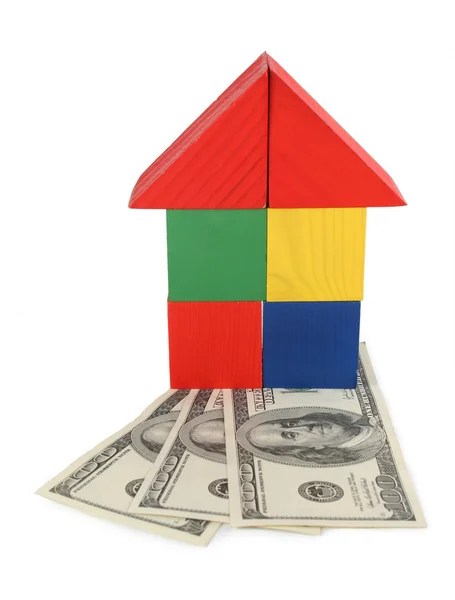 Speelgoed huis van kubussen en dollars — Stockfoto