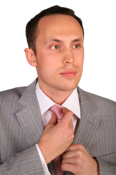 Young businessman corrects necktie — Stock Photo, Image