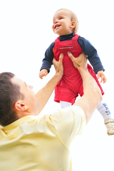 Father lifts son on hands — Stock Photo, Image
