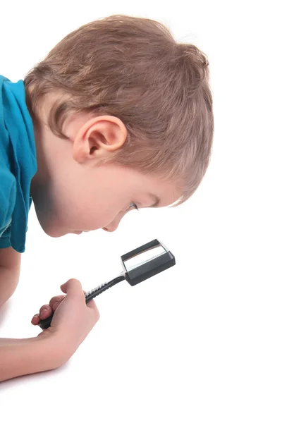 Boy looks through magnifier — Stock Photo, Image