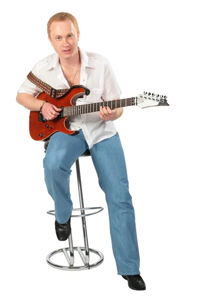 Young man with guitar on chair — Stock Photo, Image