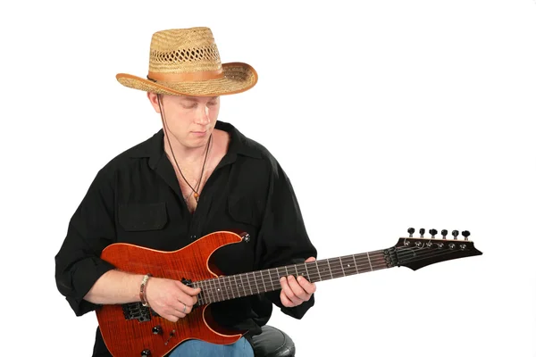 Young man in hat play on guitar — Stock Photo, Image
