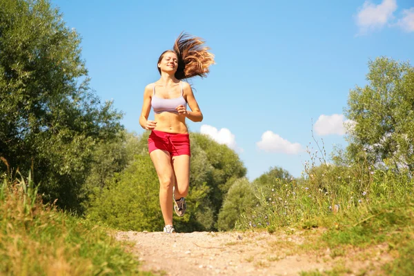 Young girl runs in forest — Stock Photo, Image