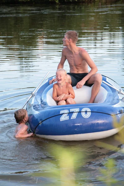 Father with son in inflatable boat — Stock Photo, Image