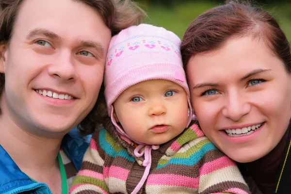 Portrait of parents with baby on nature — Stock Photo, Image