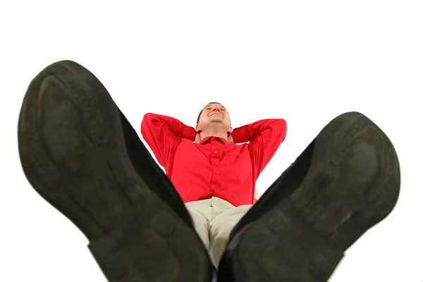 Businessman at red shirt lies by feet forward — Stock Photo, Image