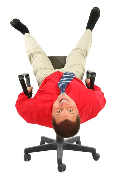 Businessman in red shirt on chair rests upside down — Stock Photo, Image