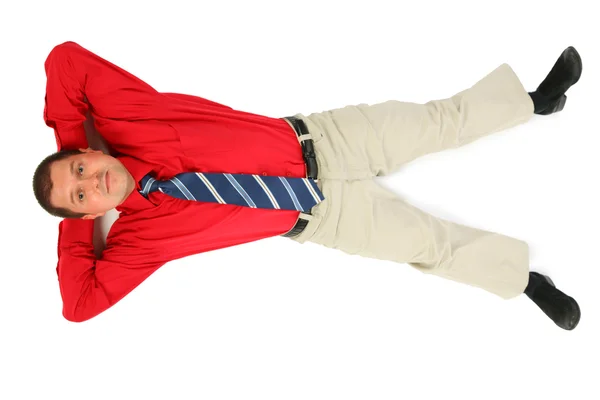 Businessman in red shirt lay on his back — Stock Photo, Image