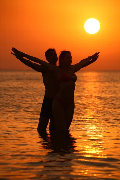 Couple in sea on sunset — Stock Photo, Image