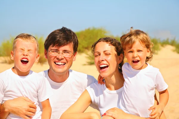 Family portrait on sandy coast — Stock Photo, Image