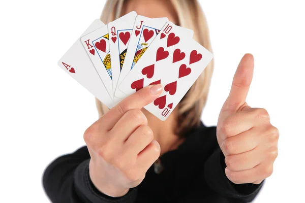 Woman holds cards in hand and does gesture by thumb — Stock Photo, Image