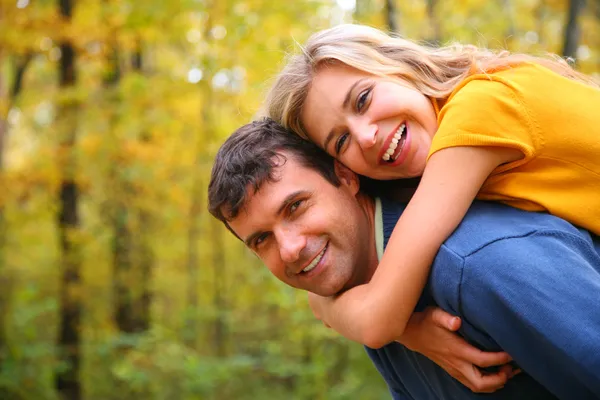 Young blond embraces man from back — Stock Photo, Image