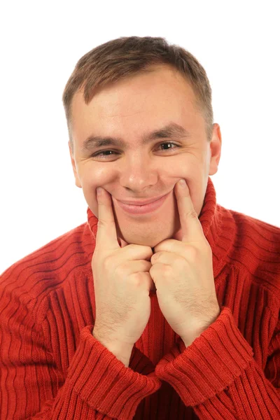 Молодой человек заставляет улыбаться пальцами — стоковое фото