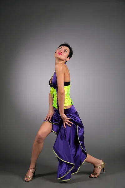 Танцююча молода жінка в темно-синій сукні — стокове фото
