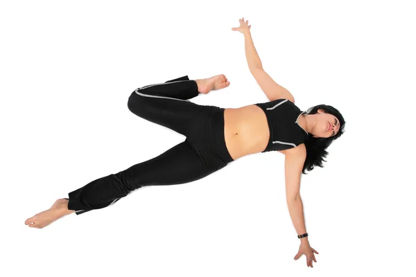 Sport woman in black makes exercise — Stock Photo, Image