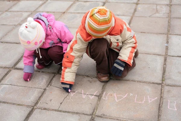 Two children with chalk on road — Stock Photo, Image