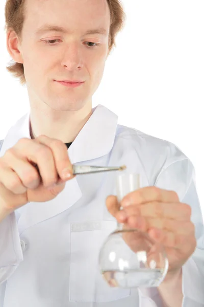 Chemist with tweezers and flask — Stock Photo, Image