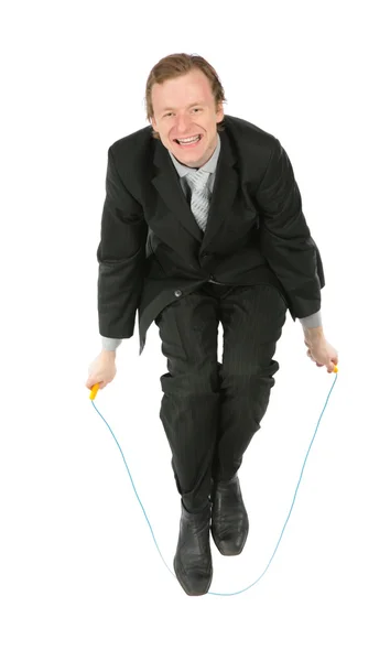 Empresário, que salta através da corda de salto — Fotografia de Stock
