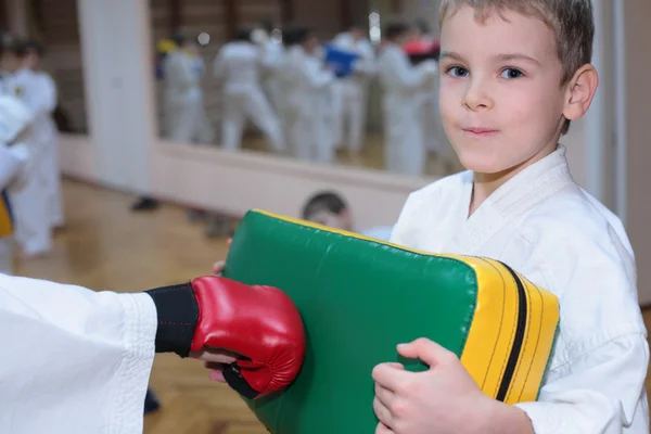 Boy trains in sports hall — Stock Photo, Image