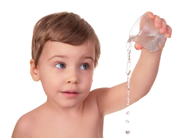 Kid pours out water from glass — Stock Photo, Image