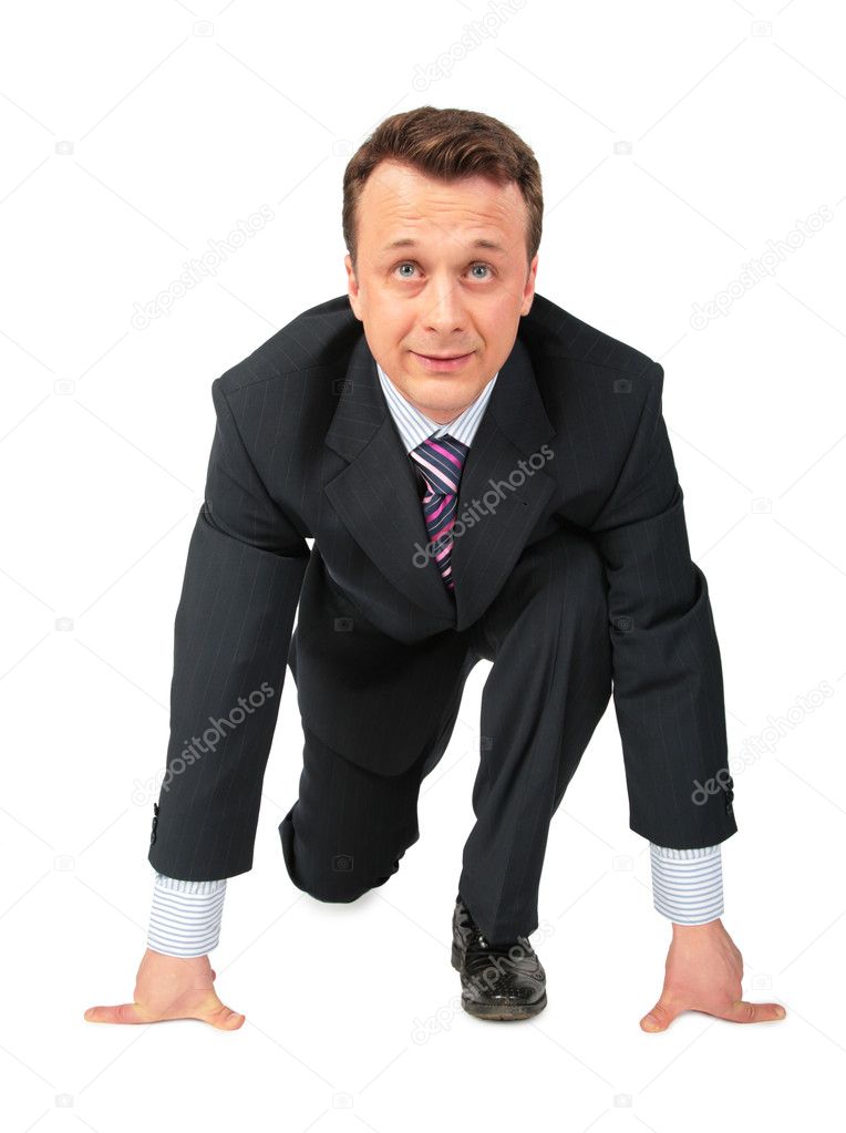 Businessman in pose of low start