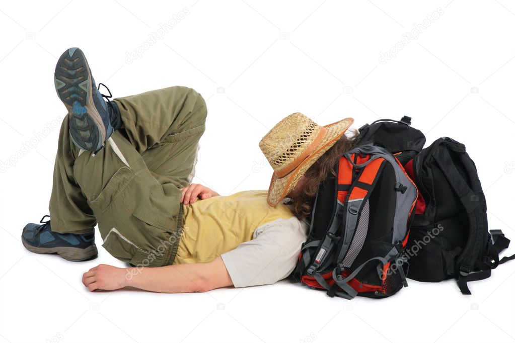Traveller in straw hat lies on backpack