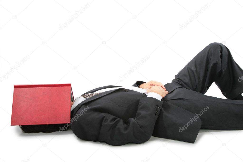 Lying businessman with book on face