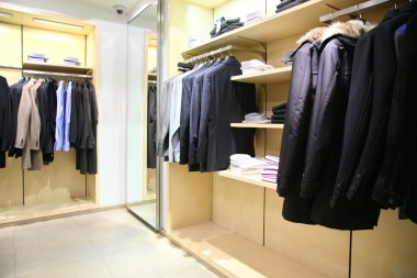 Clothes on racks in shop clipart